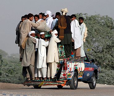 File photo shows residents fleeing a military offensive against the Pakistani Taliban enter Dera Ismail Khan from South Waziristan on October 19, 2009