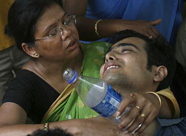 Relatives of the victims of a train accident mourn outside a mortuary in Mednipur