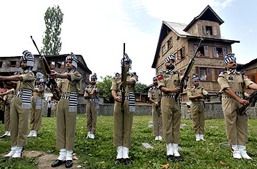 Policemen at a Srinagar graveyard on martyrs' day, July 13