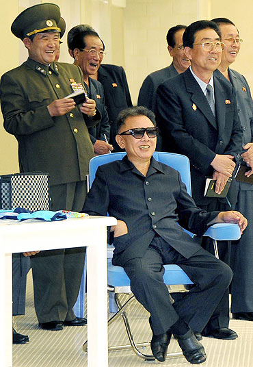 North Korean leader Kim Jong-il smiles during a visit to a swimming pool