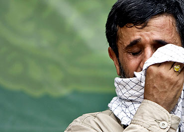 Iran's President Mahmoud Ahmadinejad cries during a religious ceremony