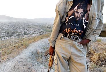 An armed Afghan man sports a photograph of Akshay Kumar on his t-shirt