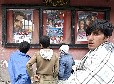 Afghan boys look at Bollywood movie posters