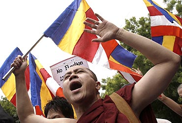 A monk shouts during a protest against Than Shwe in Delhi