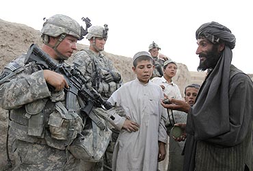 US soldiers chat with residents as they patrol in the village of Gorgan, Afghanistan