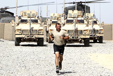 A US soldier runs in the millitary base of Gorgan, Afghanistan