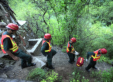 Members of the rescue team make their way to the crash site