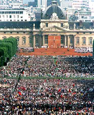 A crowd of pilgrims attend a mass on the Champs de Mars in Paris