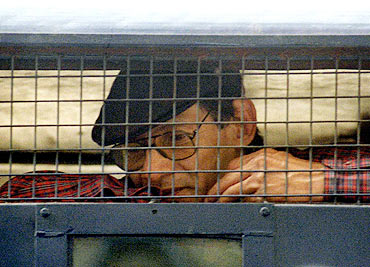 Charles Sobhraj sits inside a police van outside a New Delhi court in 1997