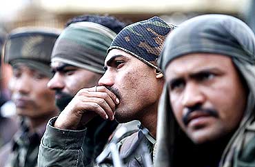 Indian soldiers rest during a gun battle with militants in Dadsar village near Srinagar.