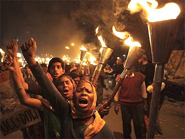 Activists shout slogans during a torch rally to mark the 25th anniversary of the Bhopal gas disaster