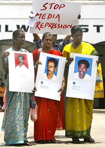 Demonstrators hold pictures of relatives and friends who went missing during Sri Lanka's war with the LTTEin Colombo on September 9, 2009