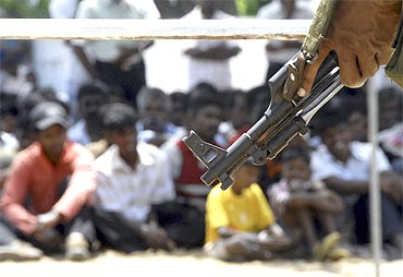 A Sri Lankan soldier stands guard during the resettlement of refugees to their homes in Mannar, western Sri Lanka June 9, 2009