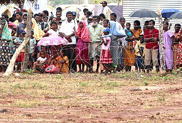 Refugees from the Settikulam Internally Displaced People camp in northern Sri Lanka wait to meet their relatives August 15, 2009