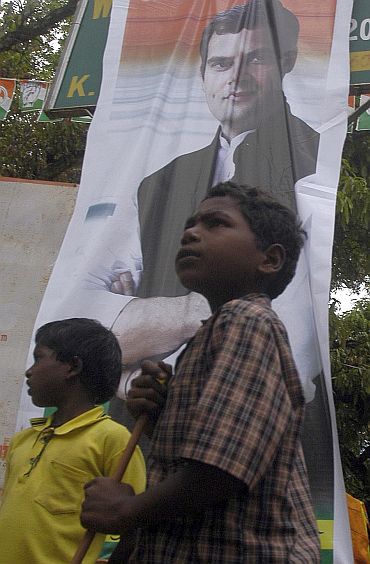 Children pose with a banner of Rahul Gandhi in Karnataka