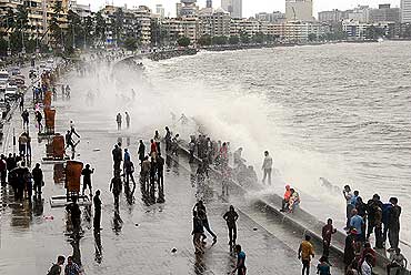 A violent sea tries to break the barrier at Marine Drive.