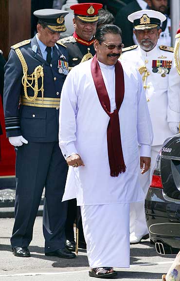 Sri Lanka's President Mahinda Rajapaksa (front), commander of the air force Air Vice Marshal Roshan Gunathilake (L) and army commander Lieutenant General Jagath Jayasuriya (2nd L), Commander of the Navy Vice Admiral Thisara Samarasinghe at the parade