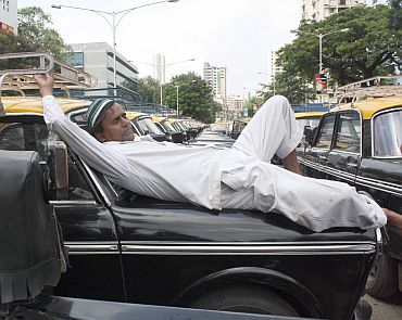 A cab driver takes a nap