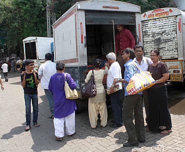 People hitch a ride in a goods carrier