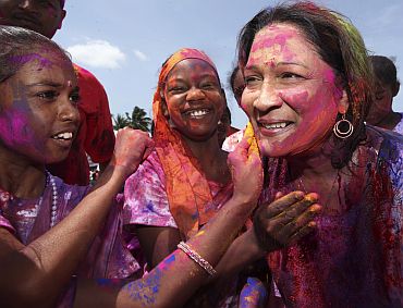 Newly elected leader of the opposition party United National Congress, Kamla Persad Bissesar, is covered with a colours in Trinidad and Tobago