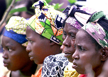 Rwandan women listen to proceedings at the first session of a new court system aimed at letting ordinary people judge those accused of killing their families and friends during the 1994 genocide