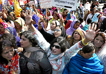 Women take part in a working women's rally in Lahore