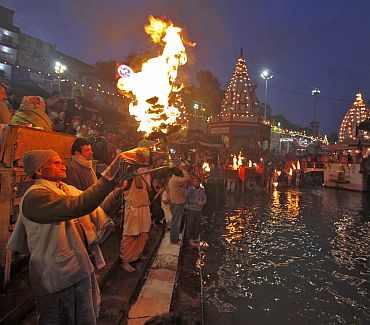 A priest performs the evening aarti on the banks of the Ganga