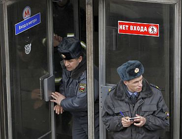 Interior Ministry officers walk out from Park Kultury metro station in Moscow