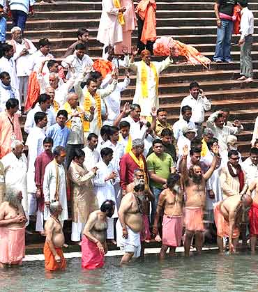 Sadhus belonging to one of the akhadas takes a dip in the Ganga