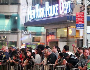 People hang around Times Square as police and fire personnel cordon off  the area