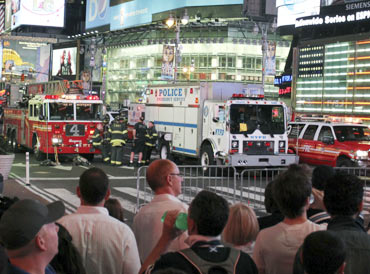 Curious onlookers watch the police in action at Times Square