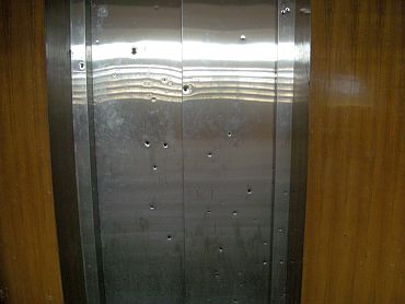A bullet-ridden lift door at the hospital