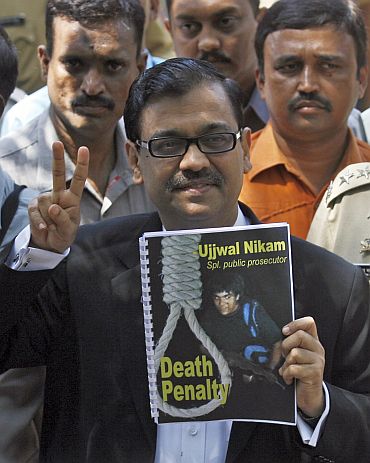 Special Prosecutor Ujjwal Nikam gestures as he speaks to the media outside Arthur Road Jail, after Mohammad Ajmal Kasab -- the lone surviving gunman of the 2008 Mumbai attacks -- was sentenced to death