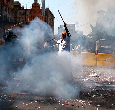 A man bursts firecrackers at the Bhendi Bazaar area. Muslim clerics and scholars have welcomed the capital punishment awarded to Kasab, saying that the court verdict has reiterated the faith of all countrymen in Indian judicial system