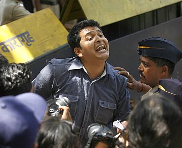 A news reporter rushes out of Arthur Road Jail as he breaks the news about Mohammad Ajmal Kasab's death sentence