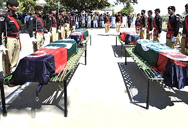 Policemen attend the funeral ceremony of five policemen killed by a Taliban bomber