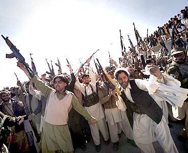 Members of the local Lashka hold their weapons while dancing in a show-of-force in Khar, Pakistan
