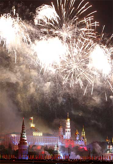 Fireworks explode above Moscow's Kremlin and the Moskva River