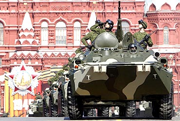 Russian soldiers drive armoured personnel carriers