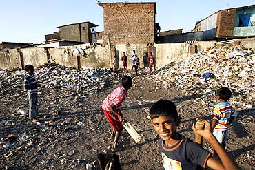 Slum children play cricket at Nehru Nagar slums in Mumbai