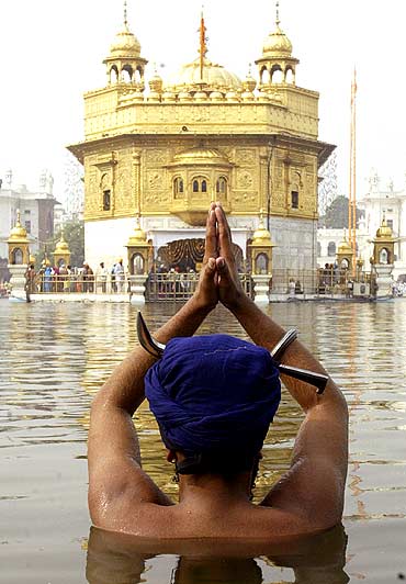 A Sikh devotee takes a dip in the pond at the Golden temple in Amritsar