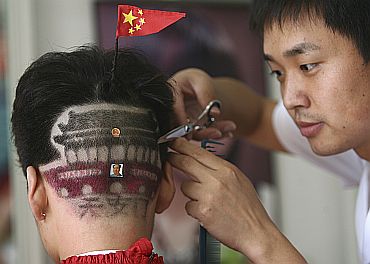 A man gets haircut featuring Tiananmen Gate in Zhengzhou