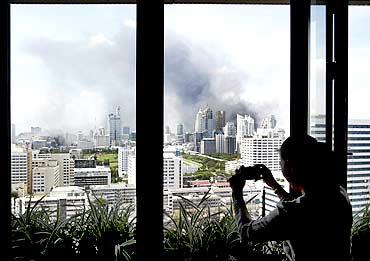 Smoke rises over buildings in Bangkok as violence rocked the city on Wednesday