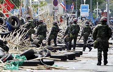 Thai soldiers patrol near the protestors' barricade