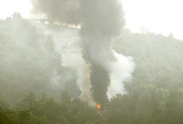 Smoke from the plane that crashed in a forested area
