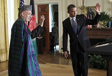Obama and Afghan President Karzai wave after a joint news conference in White House