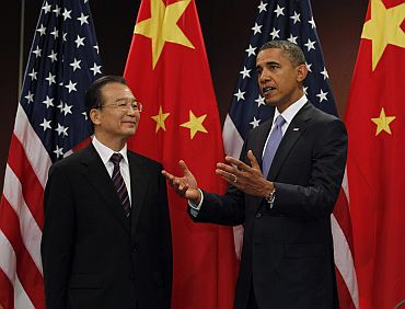 US President Obama gestures alongside China's Premier Wen at the United Nations in New York