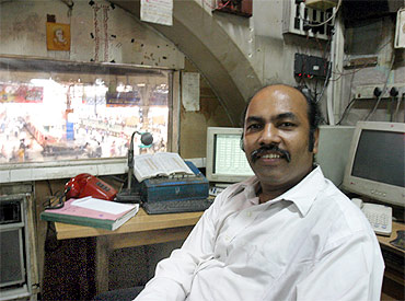 Railway announcer Vishnu Zende in his cabin at CST