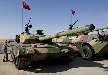 A Chinese soldier checks a PLA ZTZ-99 tank during the Peace Mission 2010 exercises in Kazakhstan