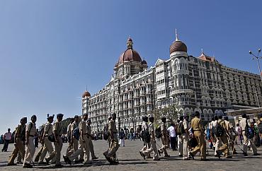 Policemen arrive for deployment at the Taj Mahal Hotel as part of security measures ahead of US President Barack Obama's visit